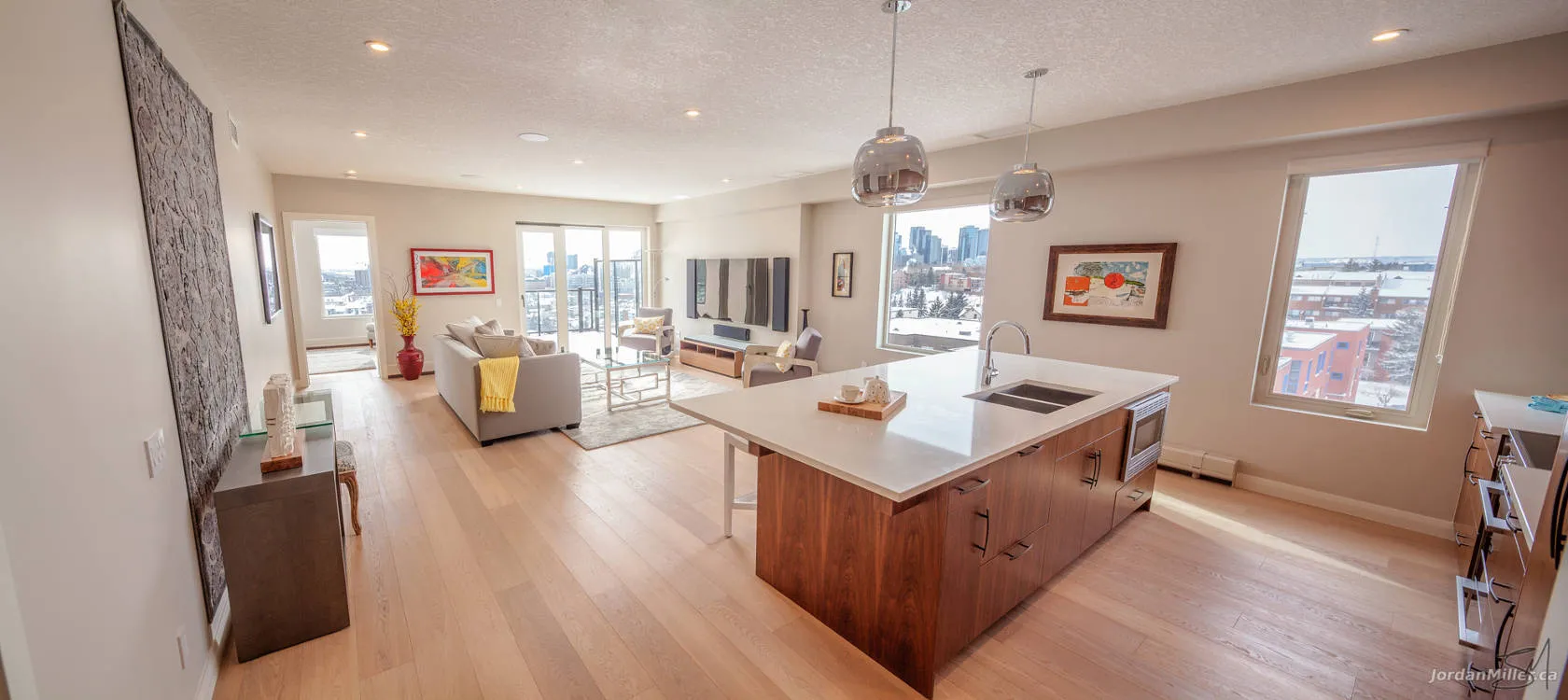 Living room opening onto a private balcony with city views